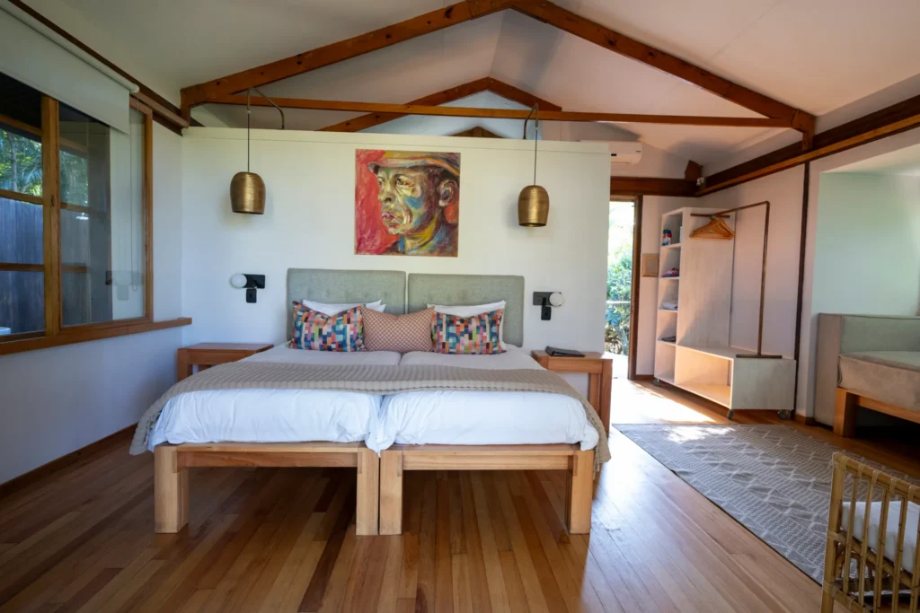 Makakatana Bay Lodge – A second view of a suite bedroom, from the window seat toward the bed.