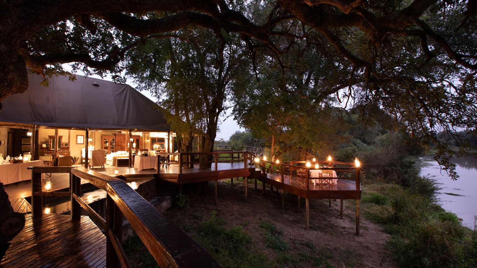 Hamiltons Tented Camp — the main deck over the Nwatswitsontso riverbed inside Kruger National Park at dusk