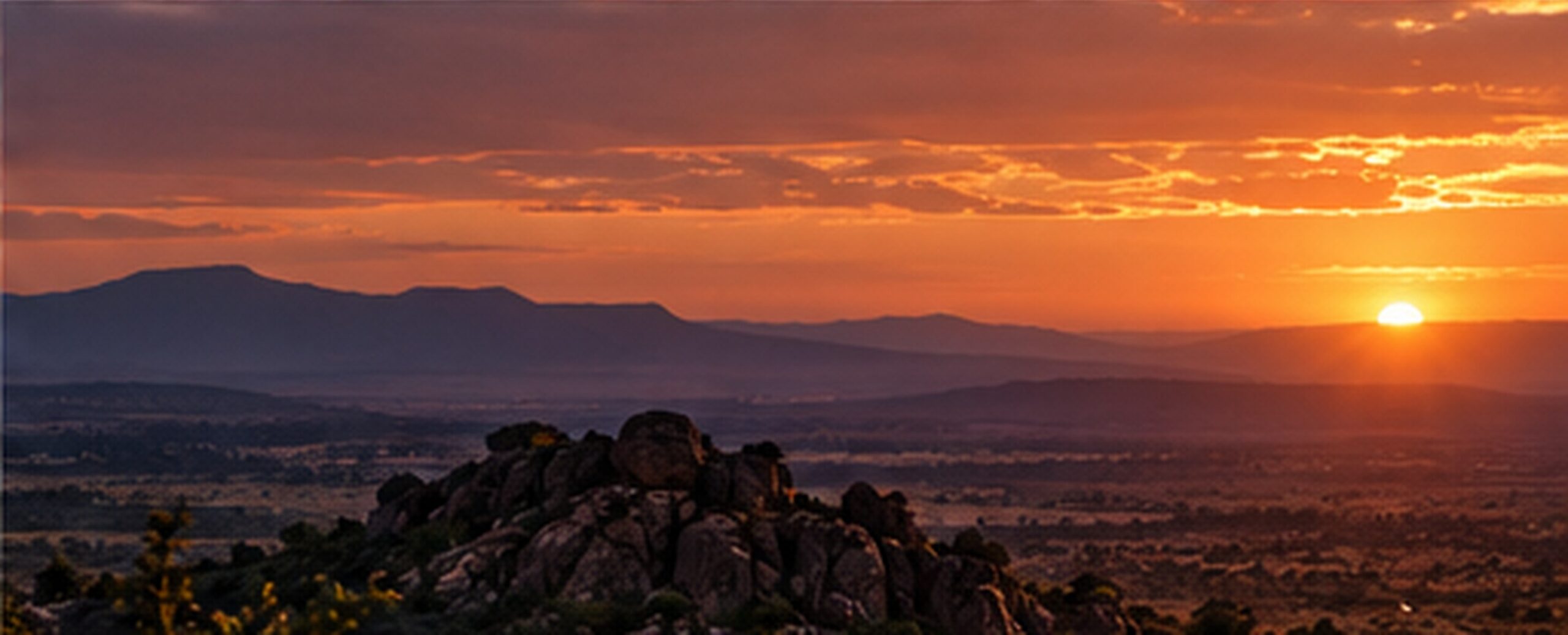 Sunset over rocky koppies and bushveld hills