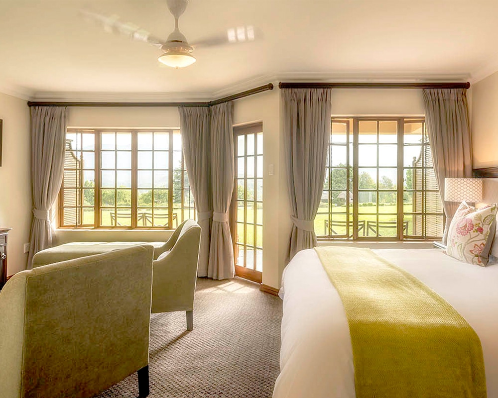 Champagne Sports Resort – Family Room Main Bedroom With Seating Area And Balcony With Mountain Views