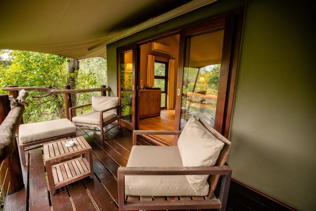 Kapama Buffalo Camp tent balcony with lounge chairs facing the bush