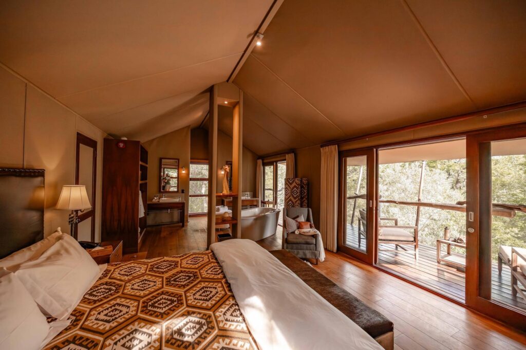 Kapama Buffalo Camp luxury tent bedroom with sliding doors to the deck