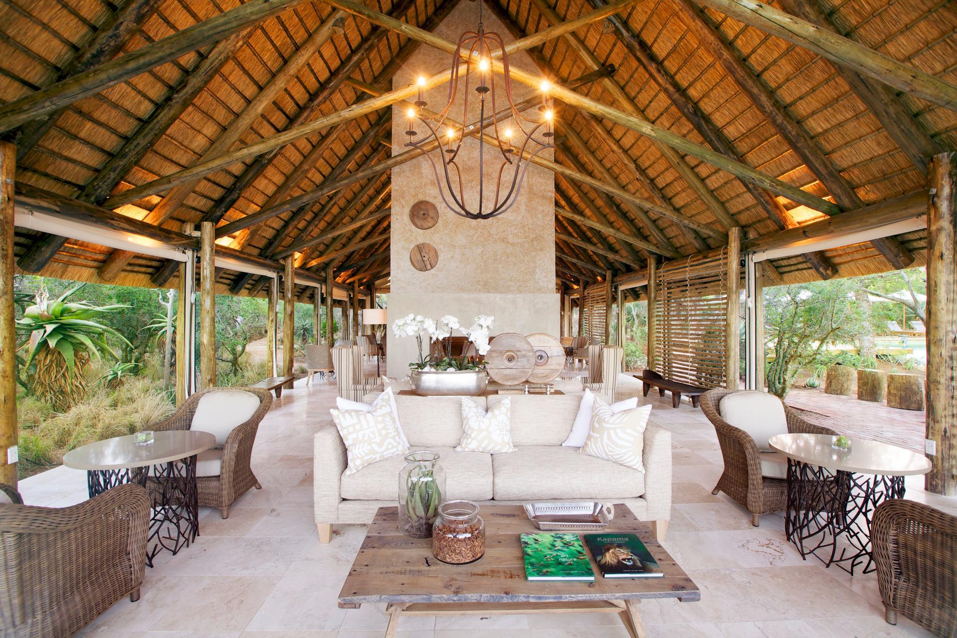 Kapama Southern Camp open-sided lounge under a high thatched roof